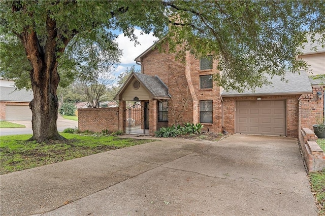 125 Pleasant Grove Ln, Waco, TX 76712 - view of front of home featuring brick siding, concrete driveway, a garage, and a gate