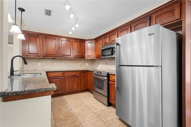 125 Pleasant Grove Ln, Waco, TX 76712 - kitchen with brown cabinetry, visible vents, a sink, stainless steel appliances, and tasteful backsplash