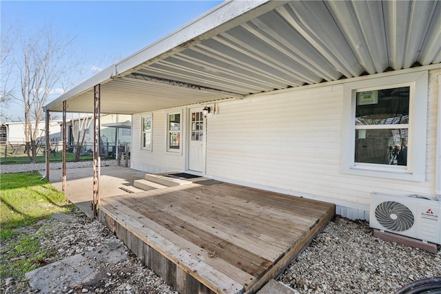 wooden terrace featuring fence, ac unit, and an attached carport