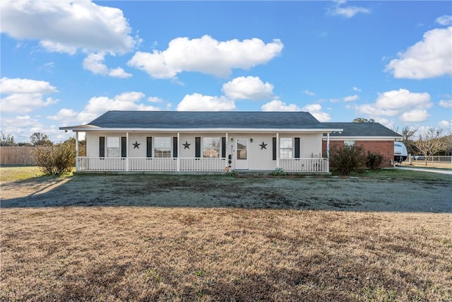 ranch-style home featuring a porch and a front lawn