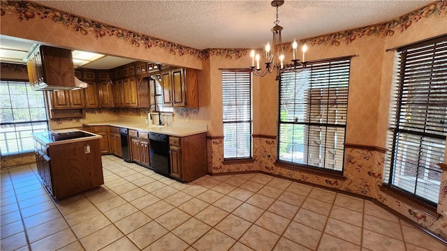 kitchen with a wainscoted wall, a notable chandelier, black appliances, a textured ceiling, and wallpapered walls