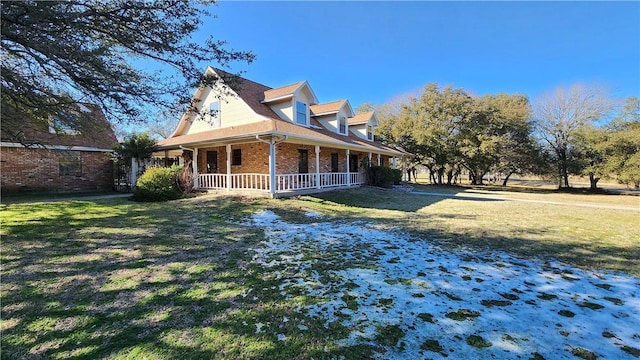 view of home's exterior with a porch, a yard, and brick siding
