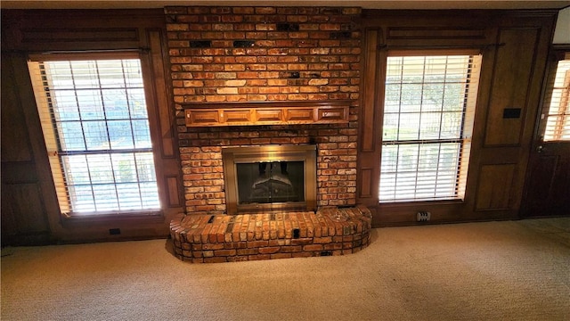 unfurnished living room with carpet floors and plenty of natural light