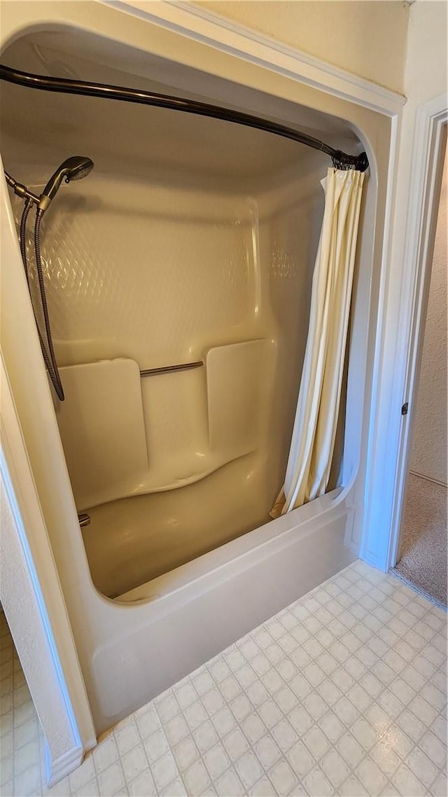 bathroom featuring tile patterned floors and shower / bath combo with shower curtain