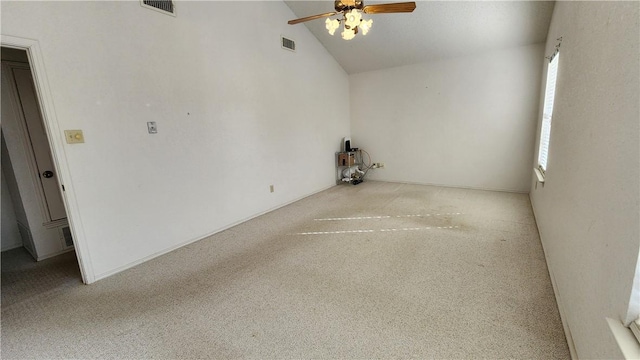 empty room featuring visible vents, high vaulted ceiling, and ceiling fan