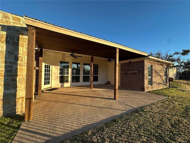back of property with a patio, fence, a ceiling fan, and brick siding