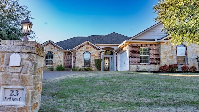 view of front facade featuring a front lawn, a garage, stone siding, and a shingled roof