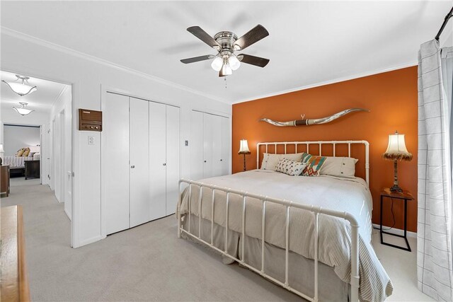 2522 S Robinson Dr, Robinson, TX 76706 - bedroom with crown molding, a ceiling fan, two closets, and carpet floors