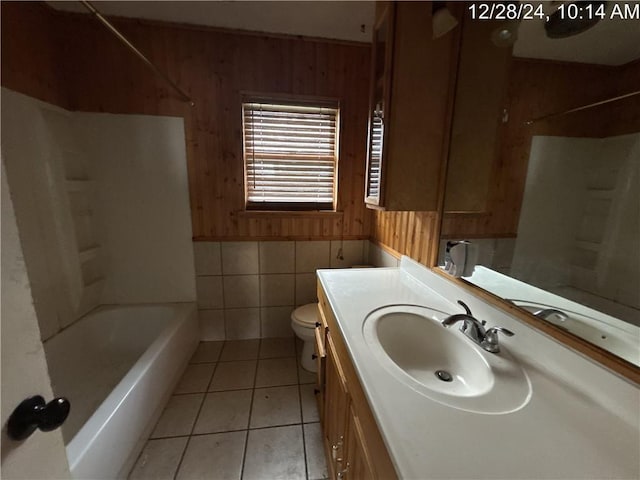 bathroom featuring tile patterned floors, wooden walls, toilet, and vanity