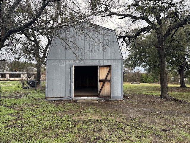 view of shed featuring fence
