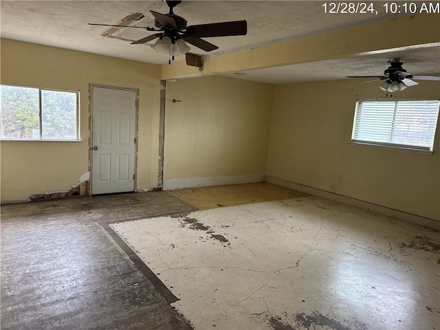 spare room with a textured ceiling and ceiling fan