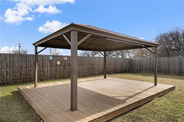 deck with a gazebo, a lawn, and a fenced backyard