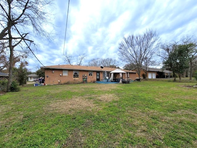 3833 Huaco Ln, Waco, TX 76710 - rear view of house featuring a gazebo, a yard, and brick siding