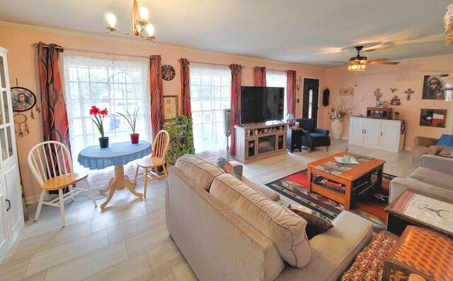 3833 Huaco Ln, Waco, TX 76710 - living room with ceiling fan, a chandelier, and ornamental molding