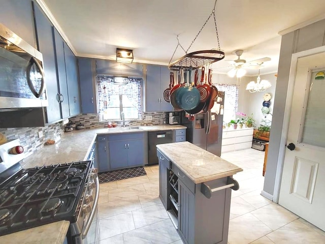 3833 Huaco Ln, Waco, TX 76710 - kitchen featuring stainless steel appliances, a sink, backsplash, blue cabinetry, and ornamental molding