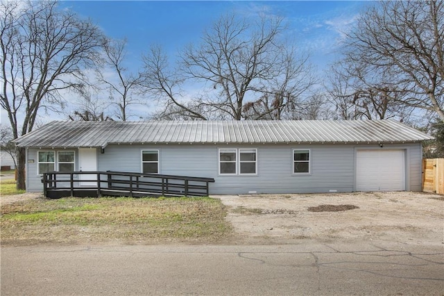 3801 Cumberland Ave, Waco, TX 76707 - view of side of property featuring an attached garage, metal roof, and dirt driveway