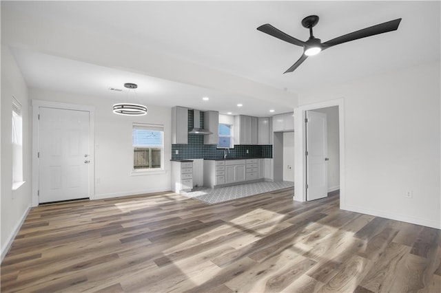 3801 Cumberland Ave, Waco, TX 76707 - unfurnished living room with wood finished floors, a ceiling fan, baseboards, and a sink