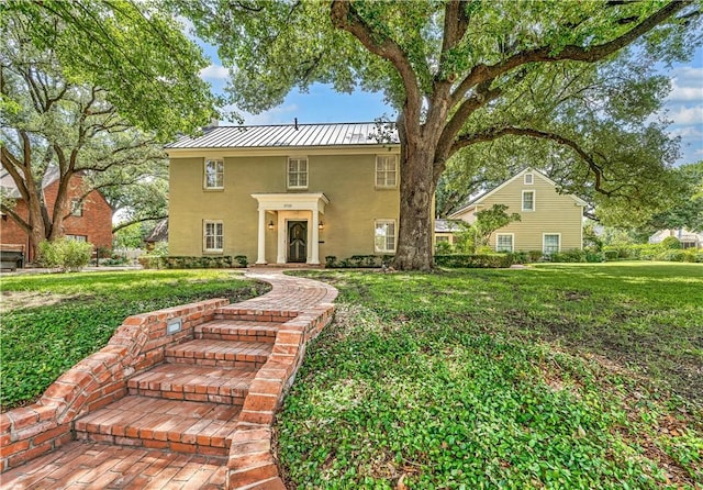 3720 Herwol Ave, Waco, TX 76710 - view of front of home with stucco siding, metal roof, a standing seam roof, and a front yard