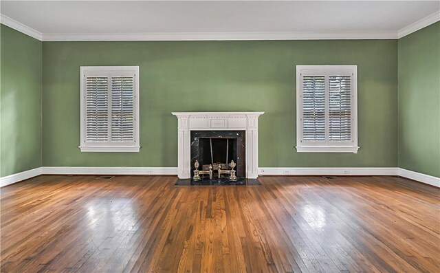 3720 Herwol Ave, Waco, TX 76710 - unfurnished living room with baseboards, wood-type flooring, a premium fireplace, and crown molding