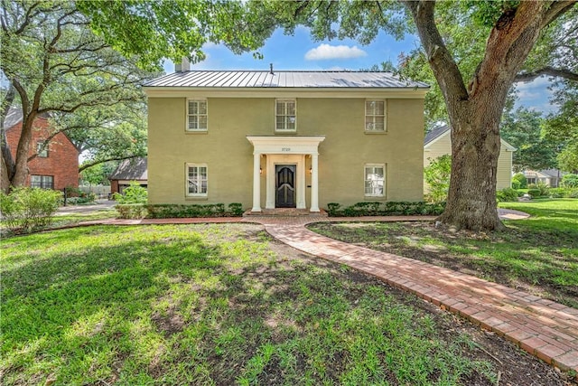 3720 Herwol Ave, Waco, TX 76710 - view of front of house with a standing seam roof, stucco siding, metal roof, and a front yard