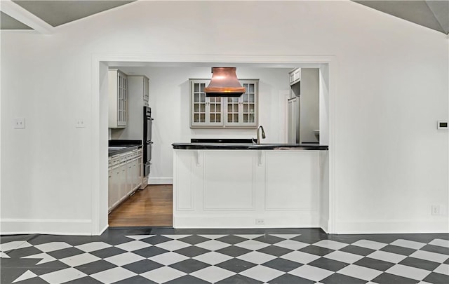 3720 Herwol Ave, Waco, TX 76710 - kitchen featuring dark countertops, glass insert cabinets, dark floors, and dobule oven black