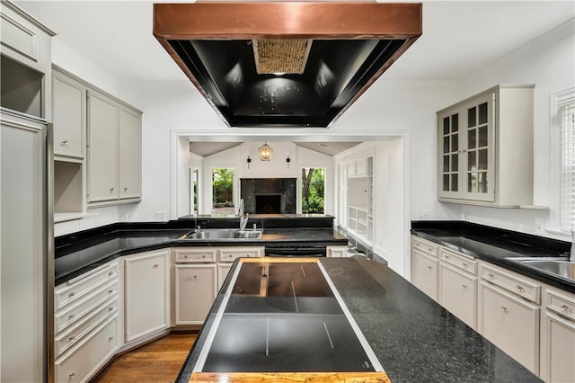 3720 Herwol Ave, Waco, TX 76710 - kitchen featuring dark countertops, open floor plan, range hood, and a sink