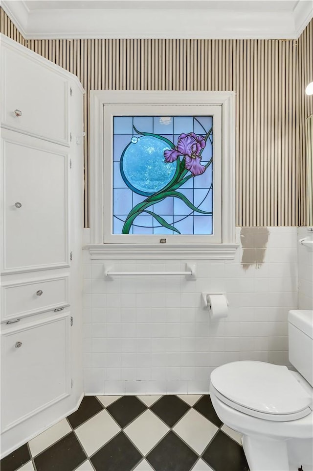 3720 Herwol Ave, Waco, TX 76710 - bathroom featuring wallpapered walls, a wainscoted wall, toilet, tile patterned floors, and tile walls
