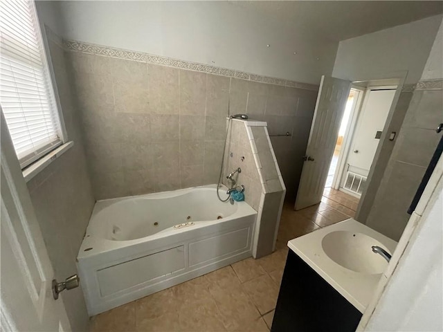 full bathroom with tile patterned flooring, visible vents, a jetted tub, walk in shower, and tile walls