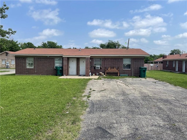 ranch-style house with brick siding and a front lawn