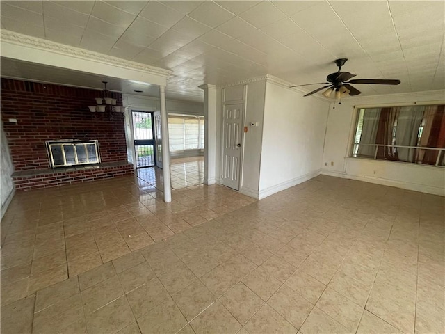 unfurnished living room featuring baseboards, a brick fireplace, brick wall, and a ceiling fan