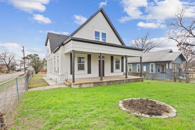 view of front of house with a front lawn, fence, and a porch