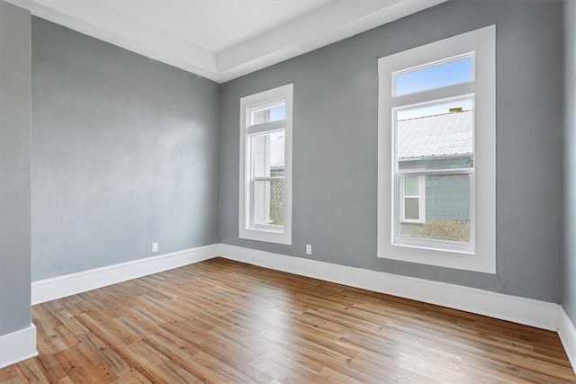 spare room with wood finished floors and baseboards