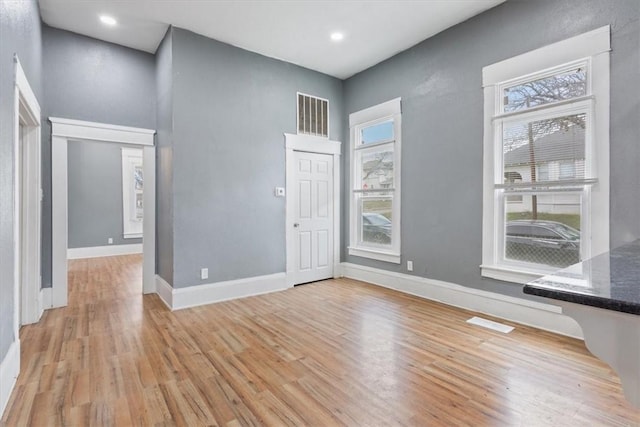 interior space featuring recessed lighting, light wood-style floors, visible vents, and baseboards