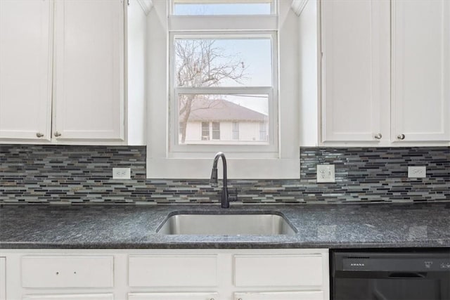 kitchen featuring black dishwasher, tasteful backsplash, white cabinets, and a sink
