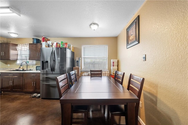 101 Hassie Ln, Waco, TX 76705 - dining area with a textured wall, a textured ceiling, and finished concrete floors