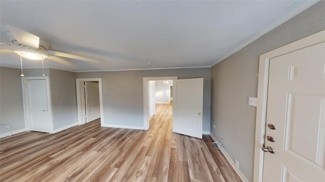 empty room with light wood-type flooring, baseboards, and ceiling fan