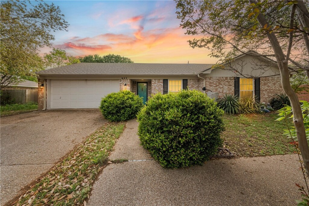 237 Westhill Dr, Hewitt, TX 76643 - ranch-style home featuring concrete driveway, brick siding, an attached garage, and a shingled roof