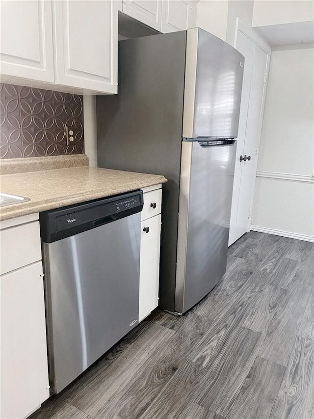 5004 Lakeshore Dr, Waco, TX 76710 - kitchen with dishwasher, light countertops, dark wood finished floors, and white cabinets