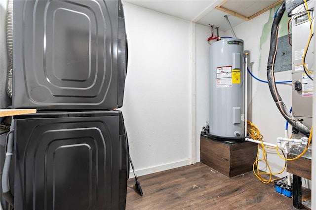 3212 Robinson Rd, Waco, TX 76706 - clothes washing area featuring baseboards, stacked washing maching and dryer, laundry area, water heater, and dark wood-style flooring