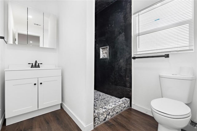 3212 Robinson Rd, Waco, TX 76706 - full bath with toilet, wood finished floors, baseboards, walk in shower, and vanity