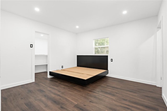 3212 Robinson Rd, Waco, TX 76706 - unfurnished bedroom featuring a walk in closet, recessed lighting, wood finished floors, and baseboards