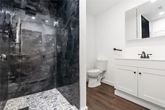 3212 Robinson Rd, Waco, TX 76706 - full bath featuring a marble finish shower, visible vents, toilet, and wood finished floors