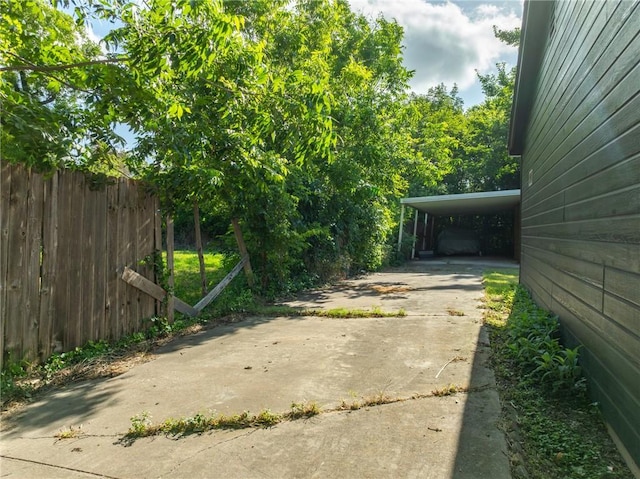 3212 Robinson Rd, Waco, TX 76706 - view of yard with a carport, concrete driveway, and fence