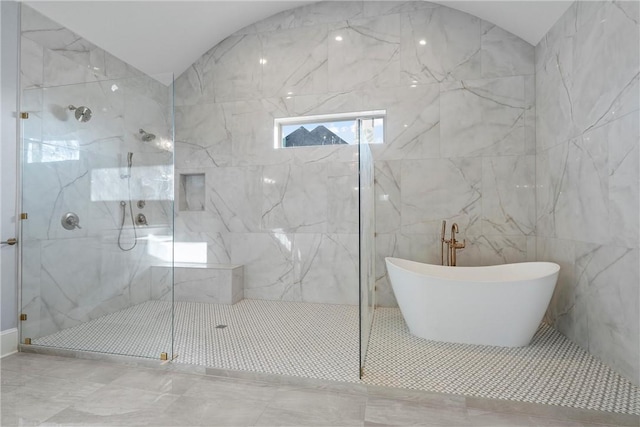 bathroom with a marble finish shower and a soaking tub