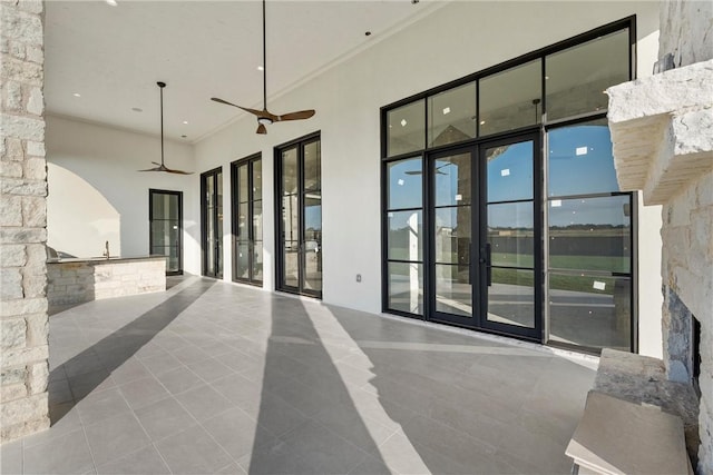view of patio / terrace with a ceiling fan, french doors, and an outdoor kitchen