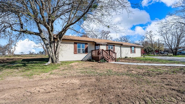 ranch-style home featuring a front yard