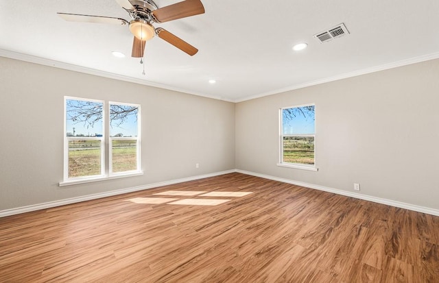 empty room featuring visible vents, a healthy amount of sunlight, baseboards, and light wood-style floors
