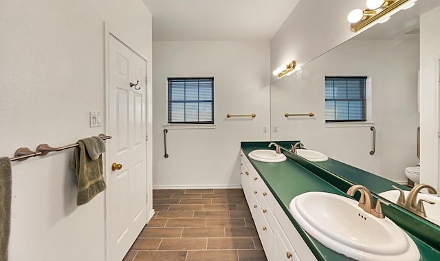 556 Old Speegleville Rd, Woodway, TX 76712 - bathroom featuring double vanity, toilet, baseboards, and wood finished floors