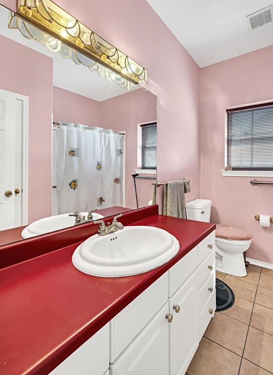 556 Old Speegleville Rd, Woodway, TX 76712 - bathroom featuring tile patterned floors, toilet, vanity, and a shower with curtain