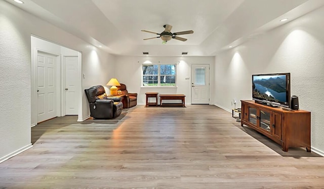 556 Old Speegleville Rd, Woodway, TX 76712 - sitting room featuring a ceiling fan, wood finished floors, a tray ceiling, a textured wall, and baseboards